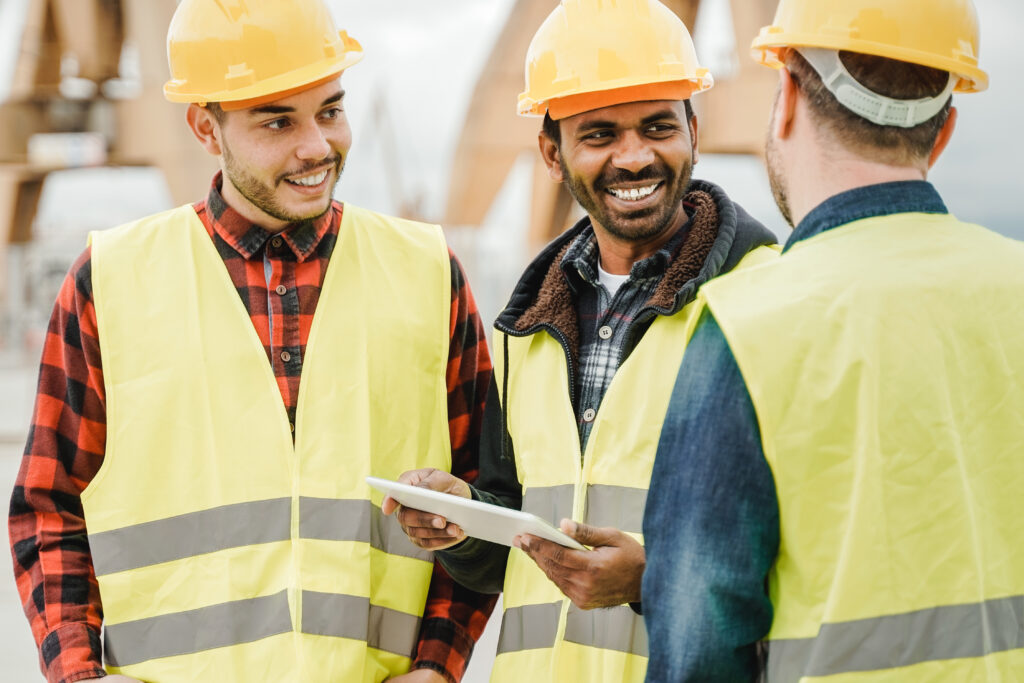 Multiracial engineer workers working at construction site using tablet computer