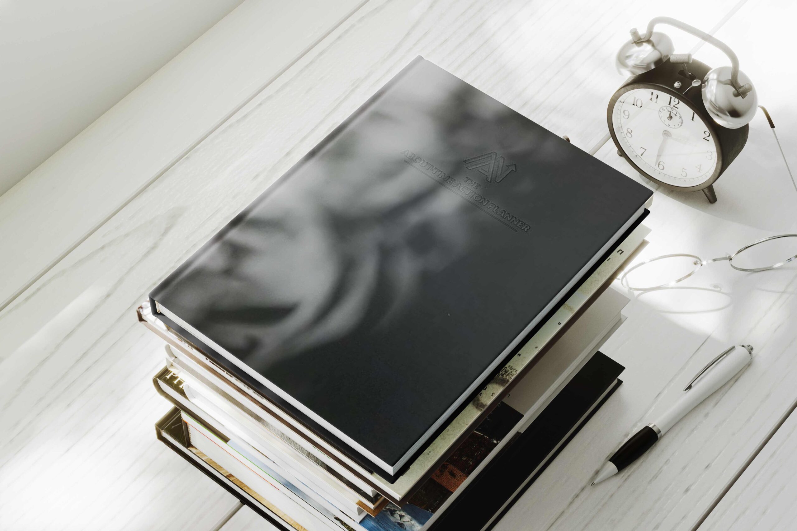 stack of books with beautiful About Time Action Planner on topl.