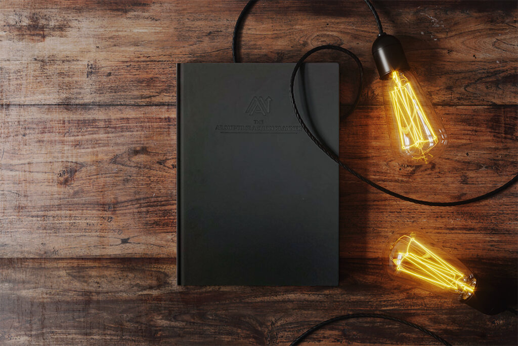 Prototype of ATAP beautiful black planner with with lit bulbs lying around it.
